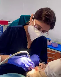 Dr. Puja Bansal examining a patient during a dental check-up