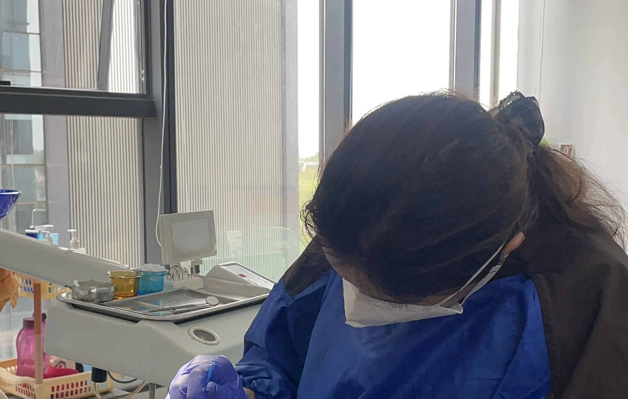 Dr. Puja Bansal treating a patient using sterile instruments and protective equipment
